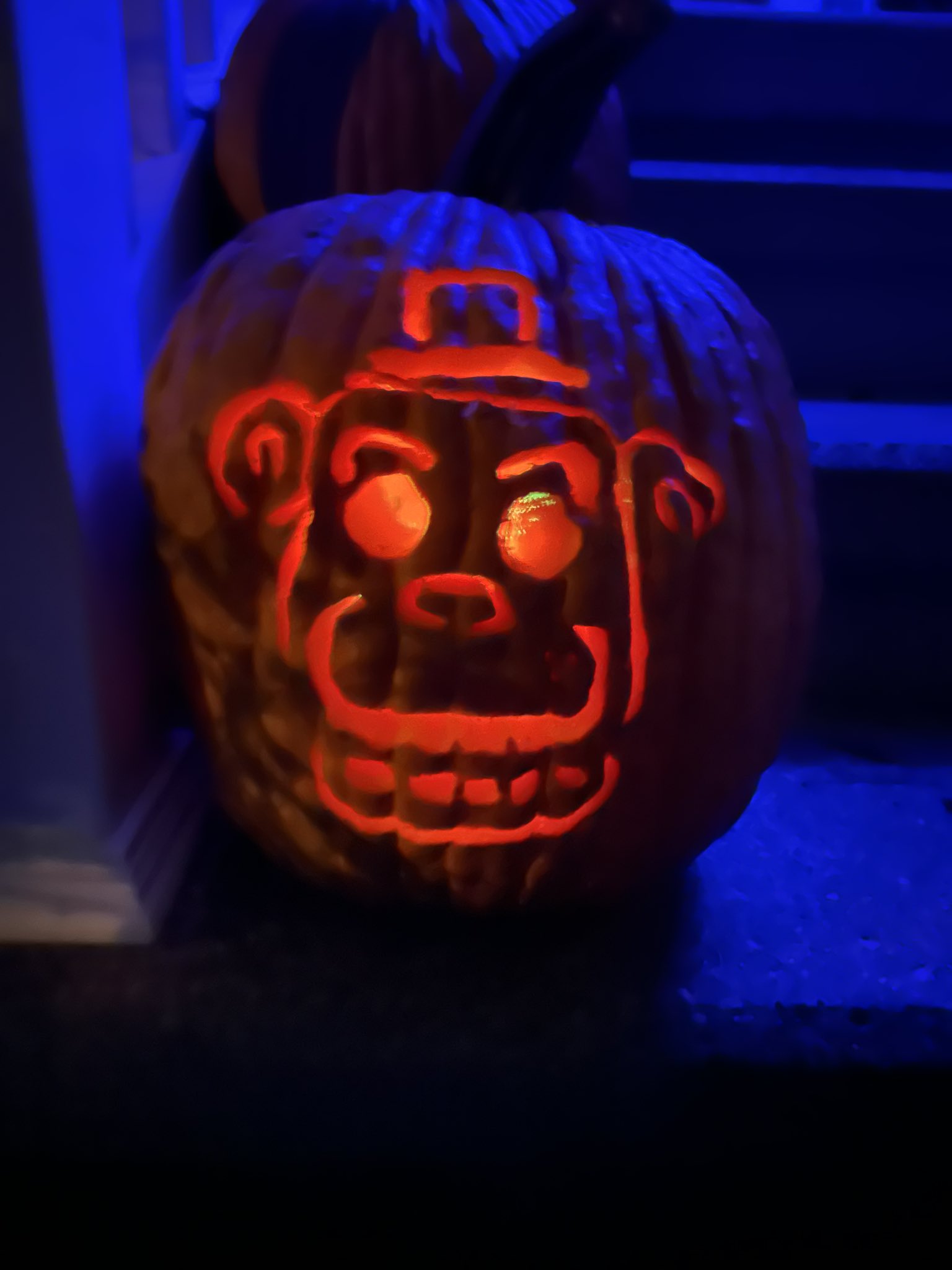 Chazz @StoneColdSteamer: Freddy Fazbear carved pumpkin, set on the front doorsteps in the dark